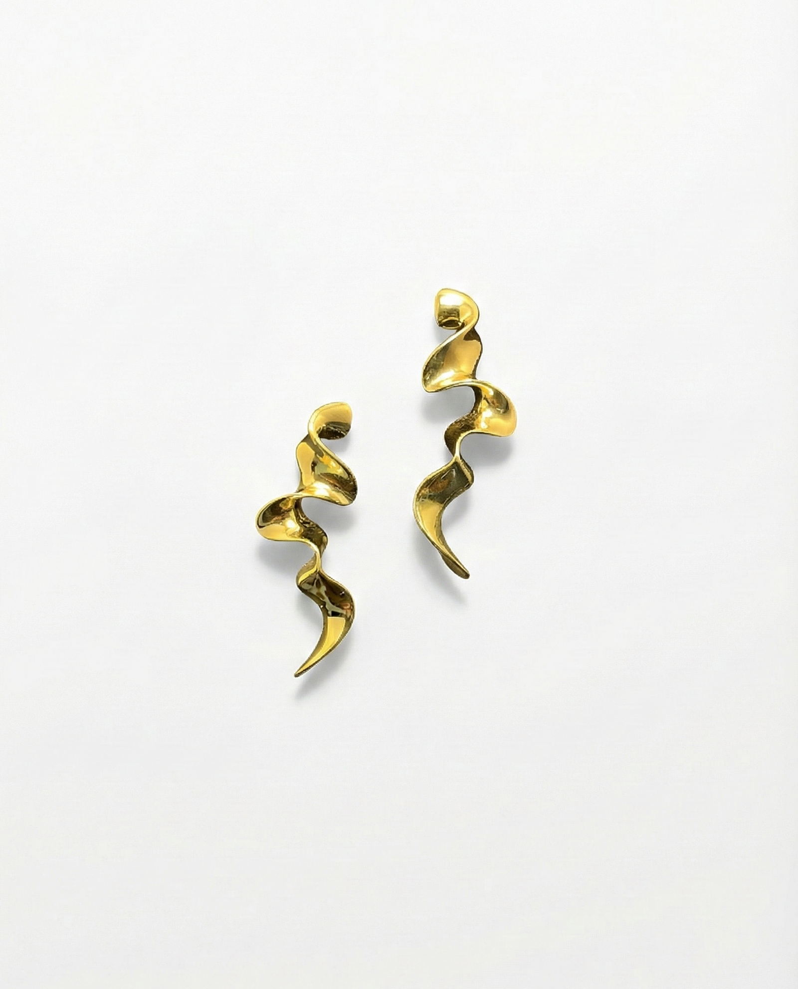 Gold spiral earrings on a white background