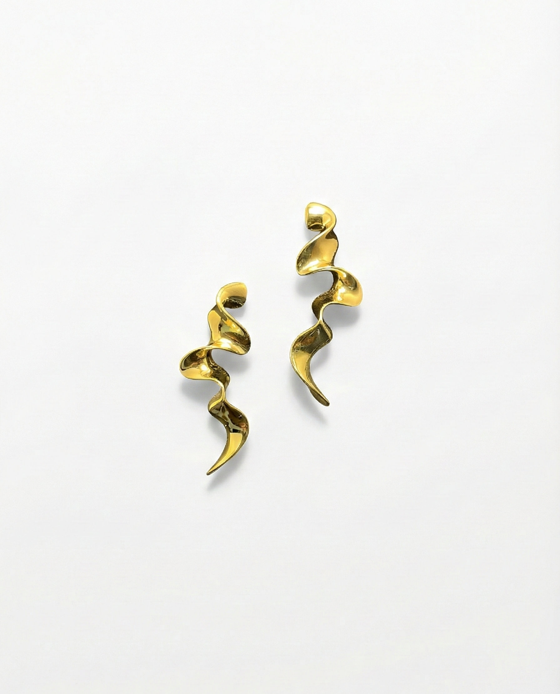 Gold spiral earrings on a white background