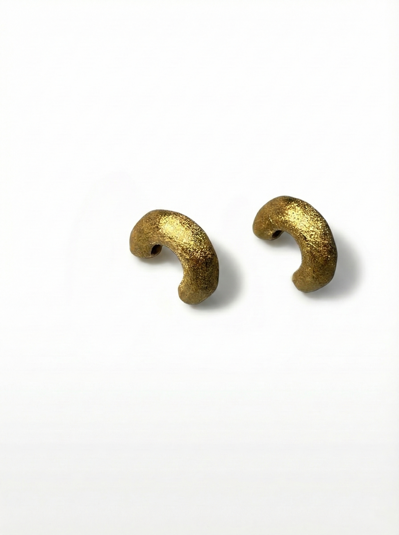 Two gold beads on a white background