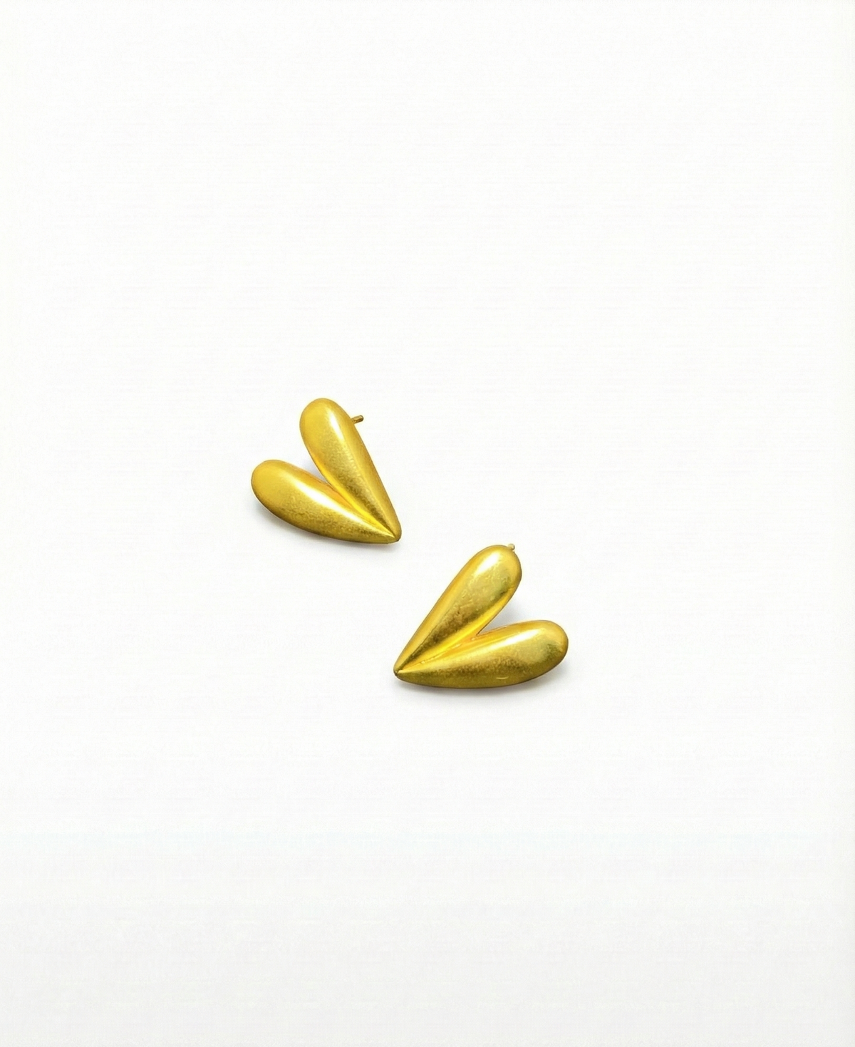 Pair of gold earrings on a white background by SFUMATO