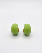 Pair of green earrings on a white background