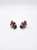 Pair of purple earrings on a white background