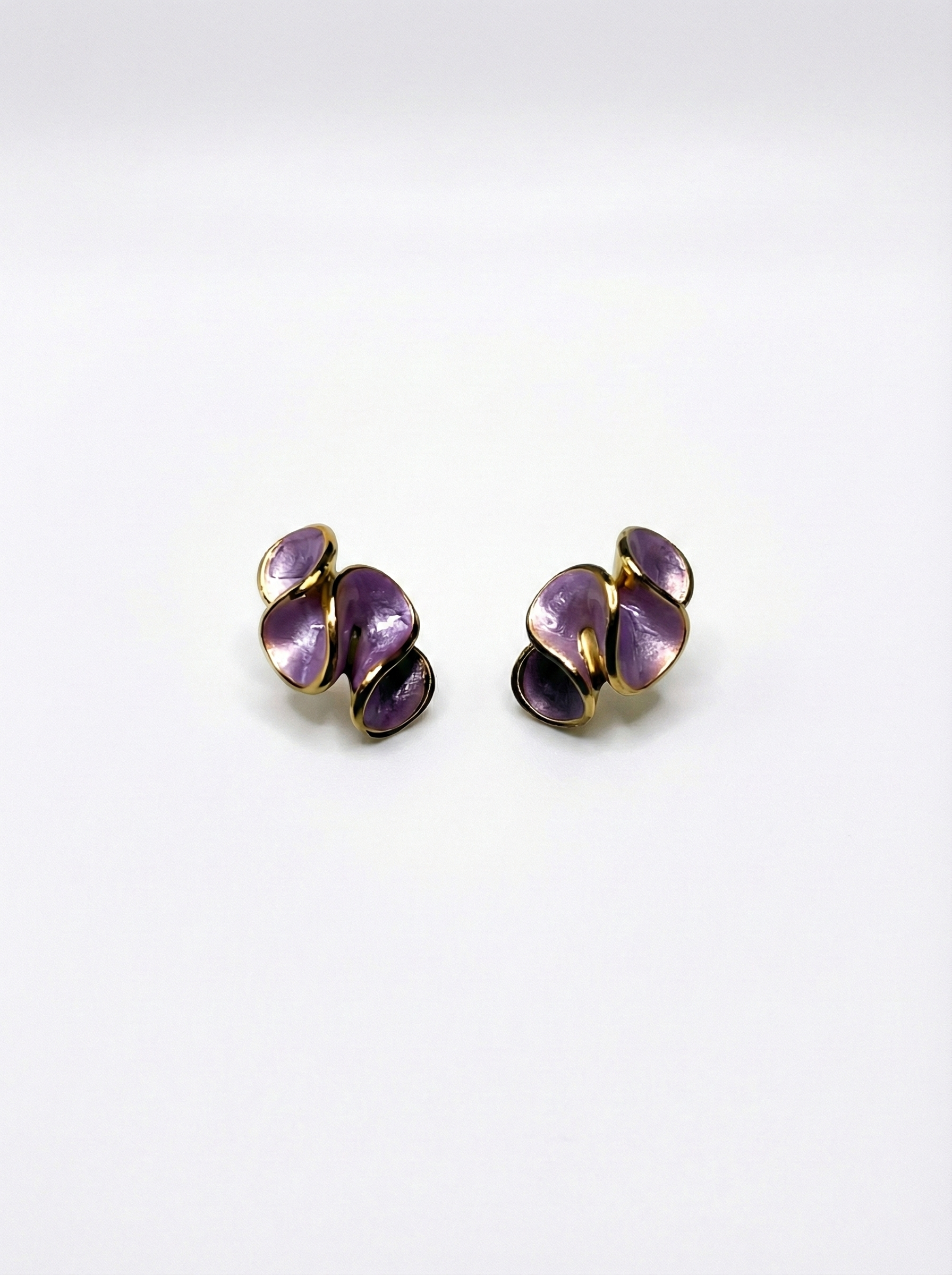 Pair of purple earrings on a white background