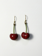 Cherry-shaped earrings on a white background