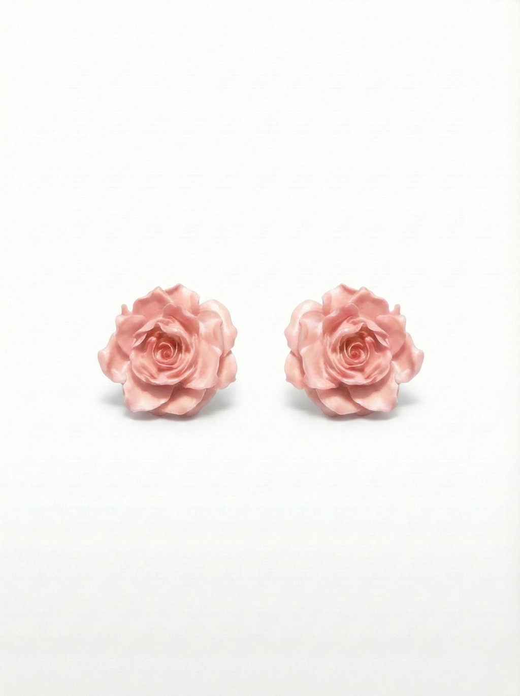 Pair of pink rose earrings on a white background