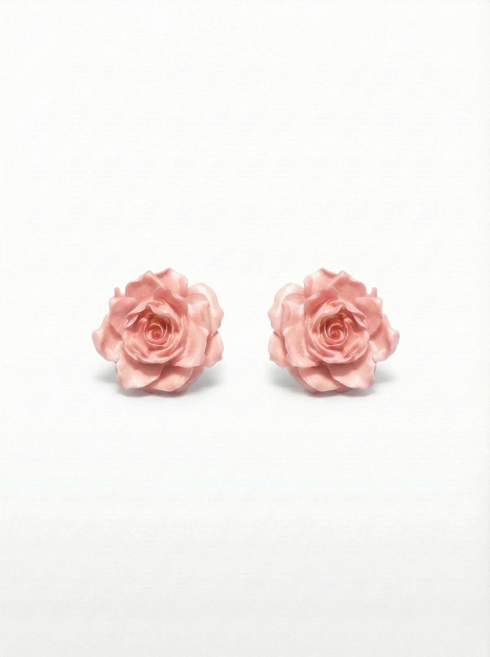 Pair of pink rose earrings on a white background