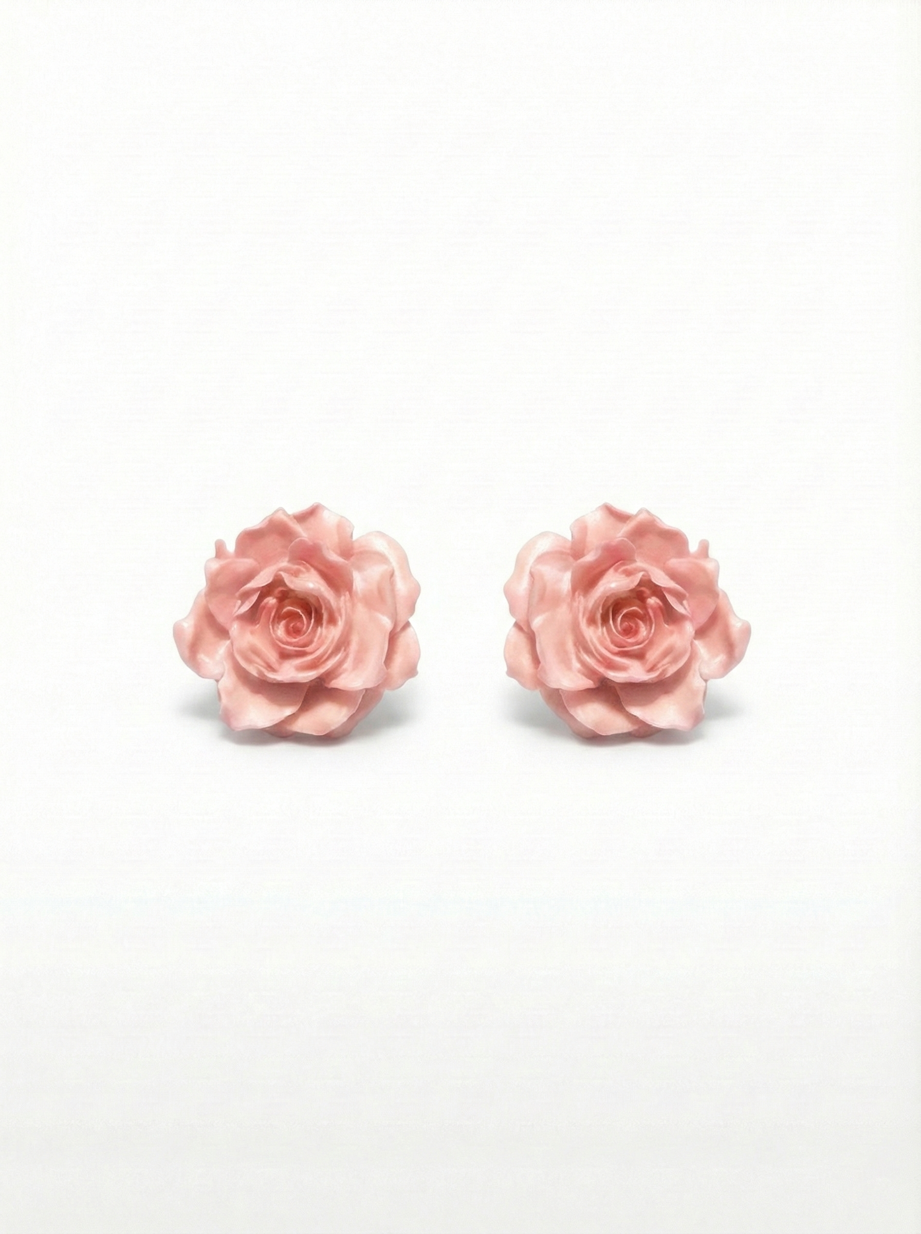 Pair of pink rose earrings on a white background