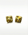 Pair of gold dice-shaped earrings on a white background